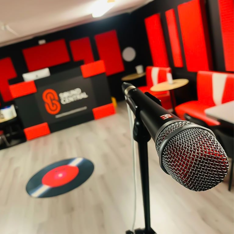 A V7 microphone in a recording studio lobby with black walls and red sound treatment.