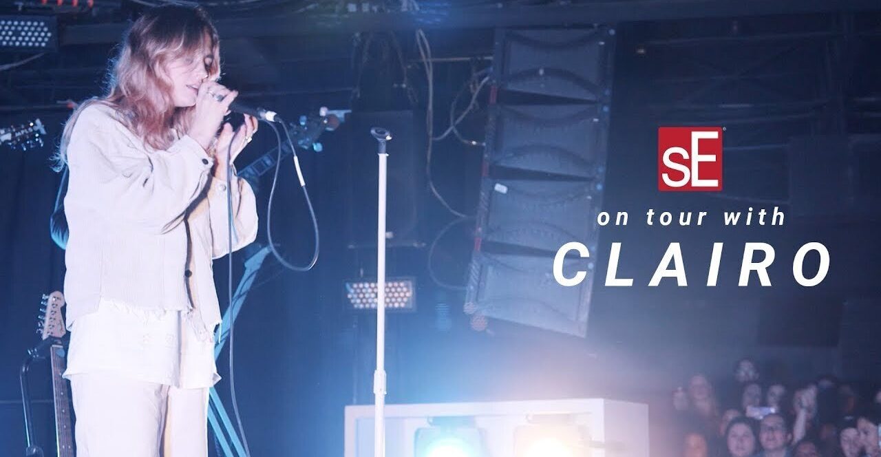 sE Electronics On Tour with Clairo YouTube cover - Female singer on stage with blue lighting in front of a crowd