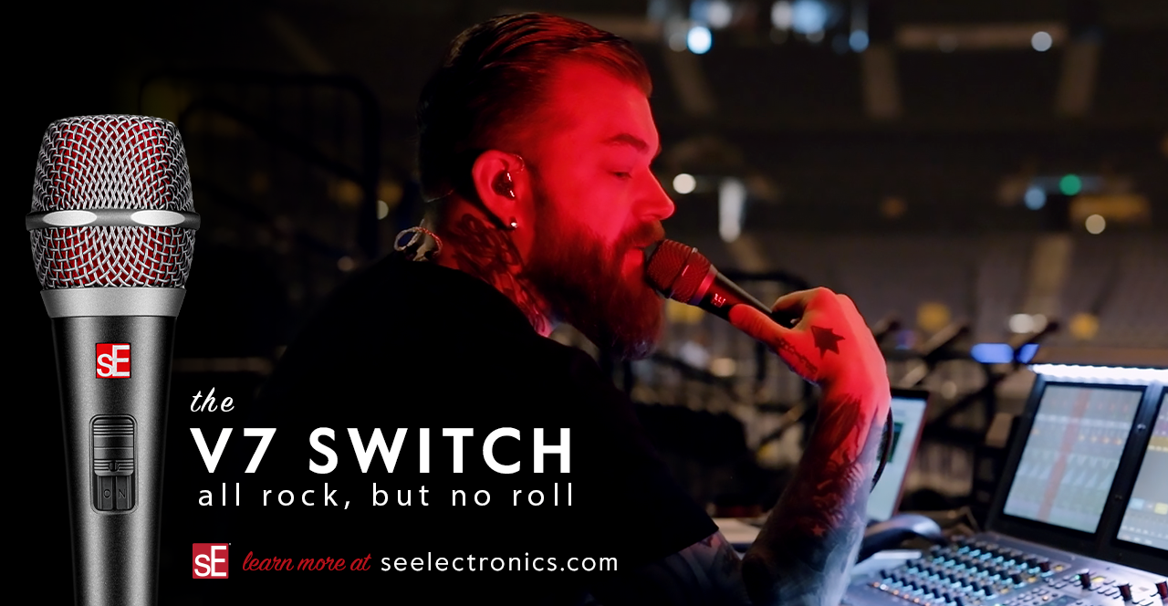 V7 Switch dynamic microphone YouTube cover - The V7 Switch being held by Paddi Krause, MON Engineer, while he sits behind a mixing console showing the sE Electronics logo and microphone switch
