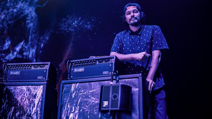 James Meslin on stage leaning on a Mesa Boogie guitar amp. guitaRF & VR2